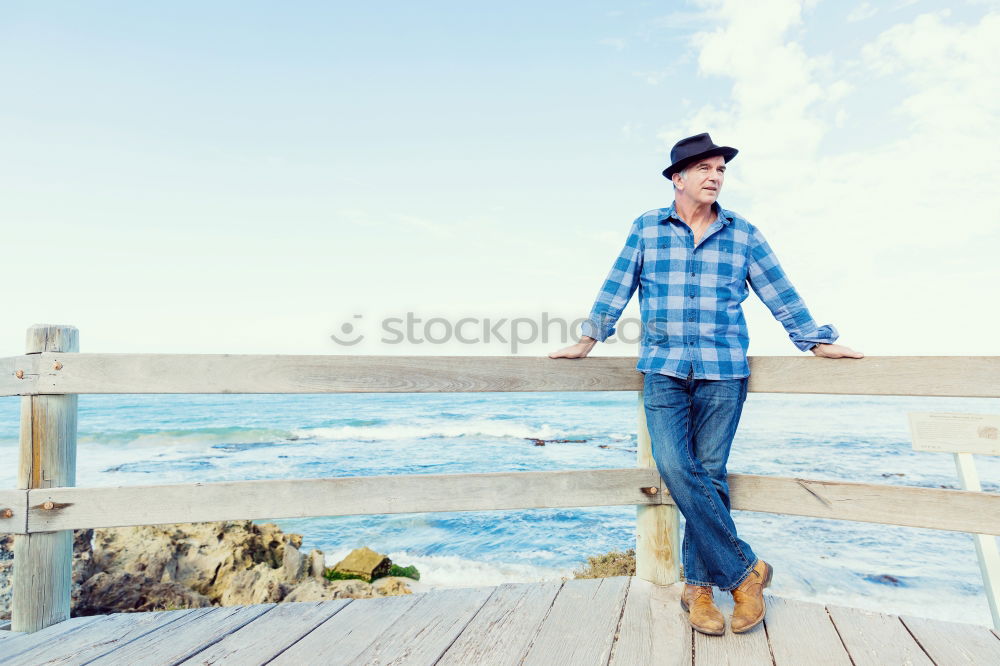 Similar – Man standing with skateboard at shore