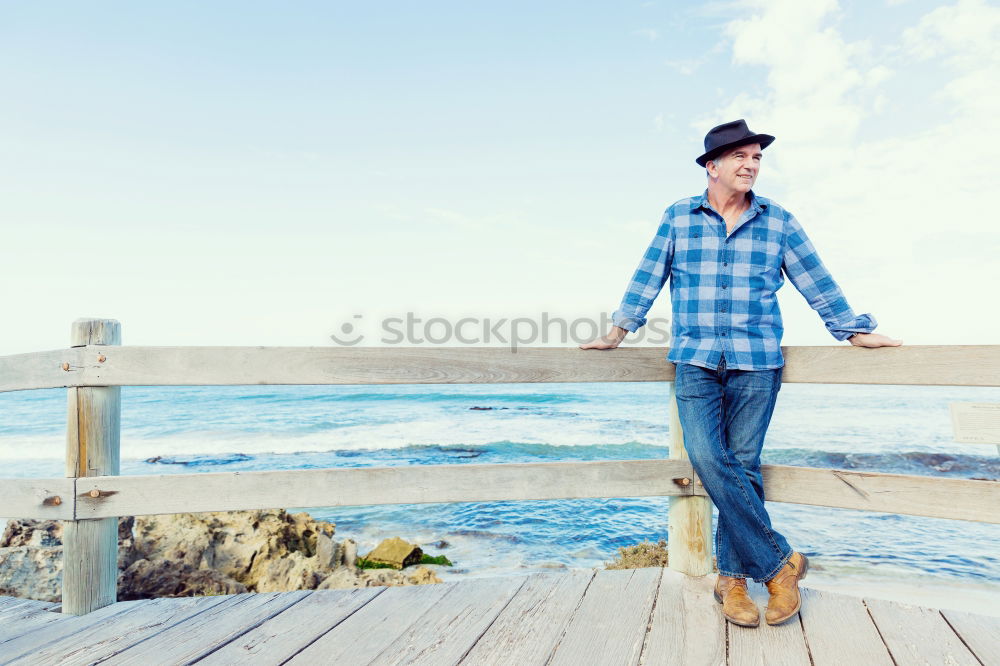 Similar – Man standing with skateboard at shore