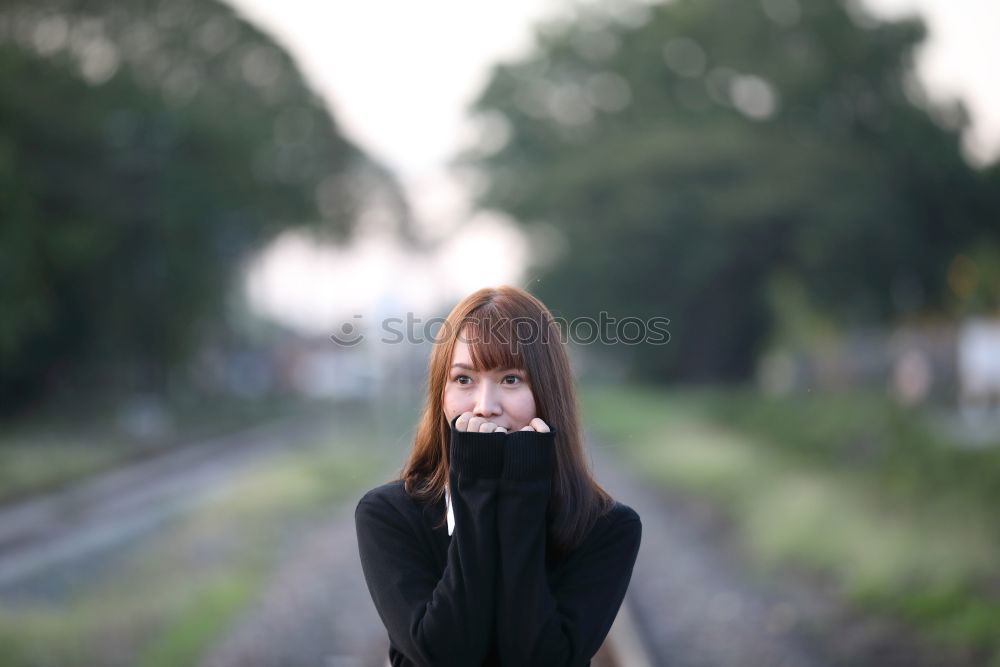 Similar – Tender girl in red looking away