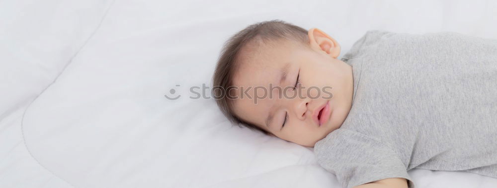 Similar – The back of a baby’s head lying on its stomach