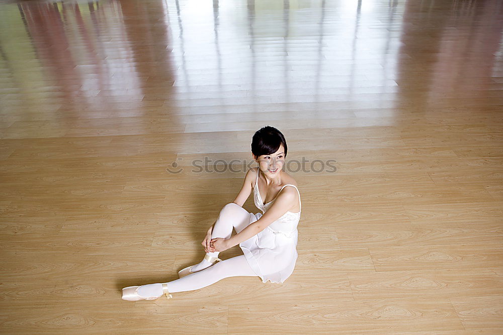 Similar – Ballerina laces up her pointe shoes