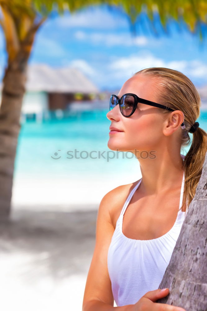 Similar – Woman in bikini sitting on bench near water