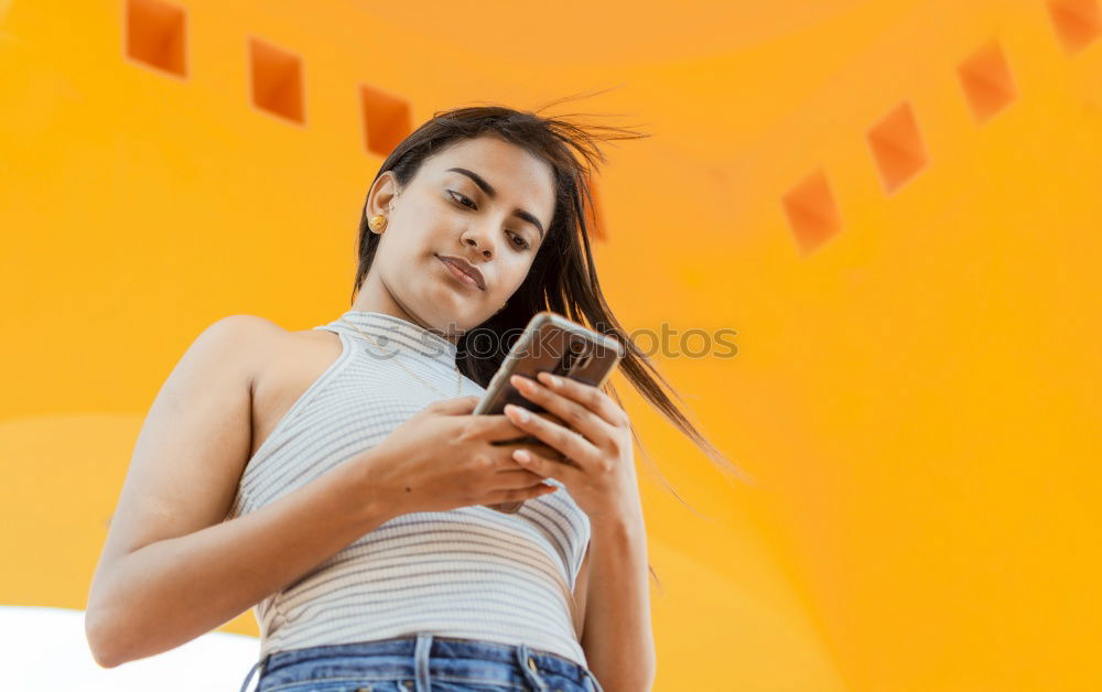 Similar – Portrait of beautiful young woman using mobile phone in the street.