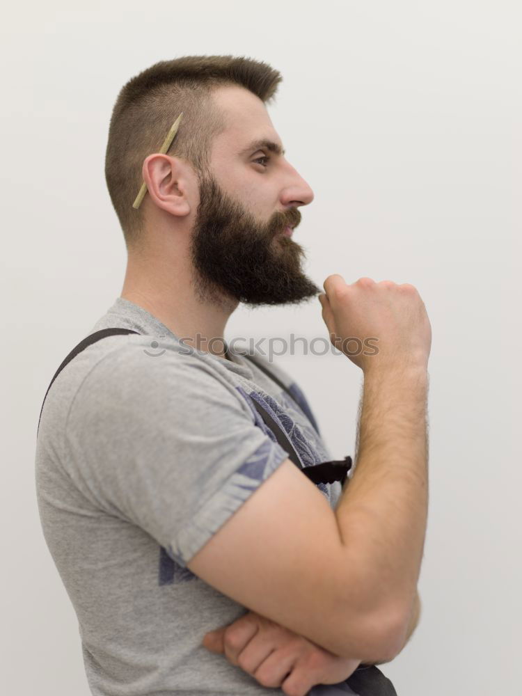 Bearded man sitting on dumpster