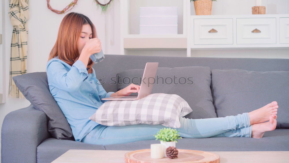 Similar – woman with laptop on her sofa at home