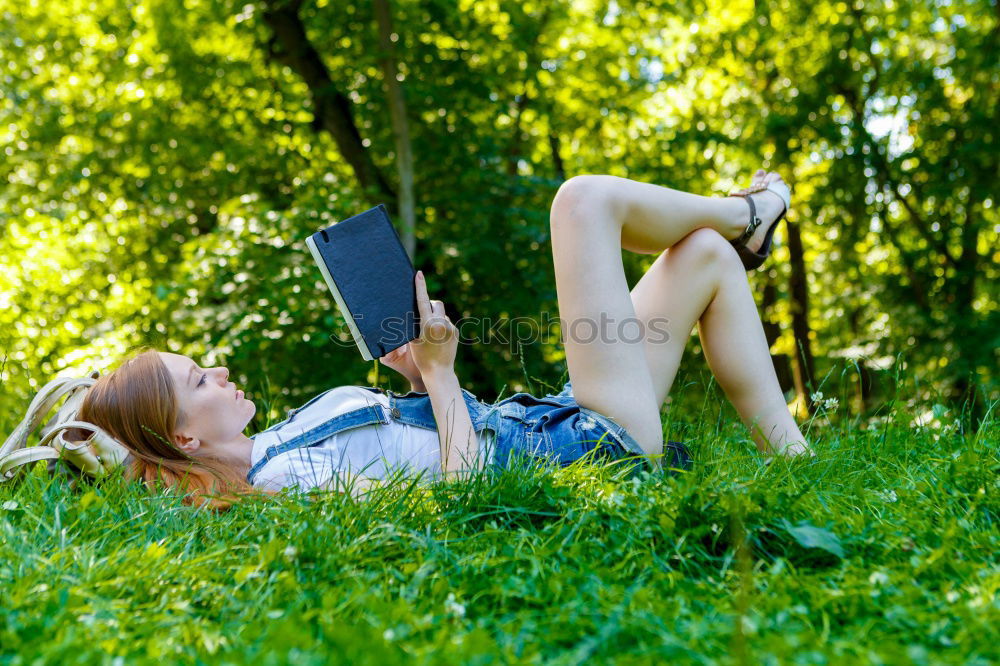 Similar – Image, Stock Photo Woman skateboarder listening music from smart phone in a park