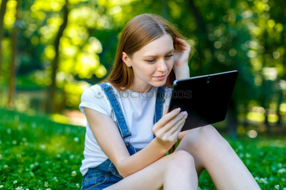 Similar – Image, Stock Photo Woman skateboarder listening music from smart phone in a park