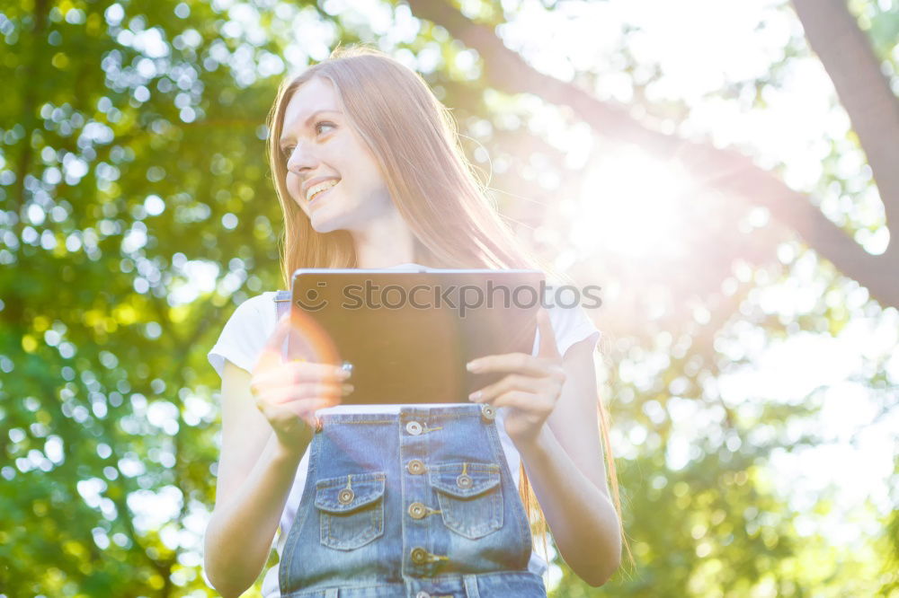 Similar – Image, Stock Photo Woman skateboarder listening music from smart phone in a park