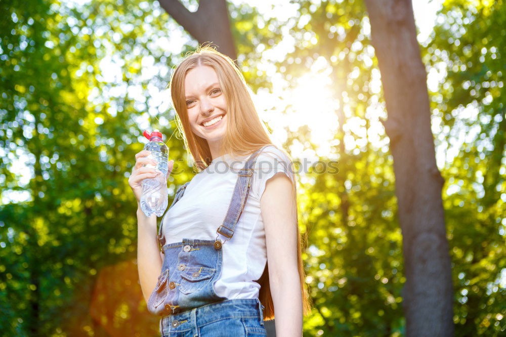 Similar – Image, Stock Photo Smiling young woman chatting on a mobile in autumn