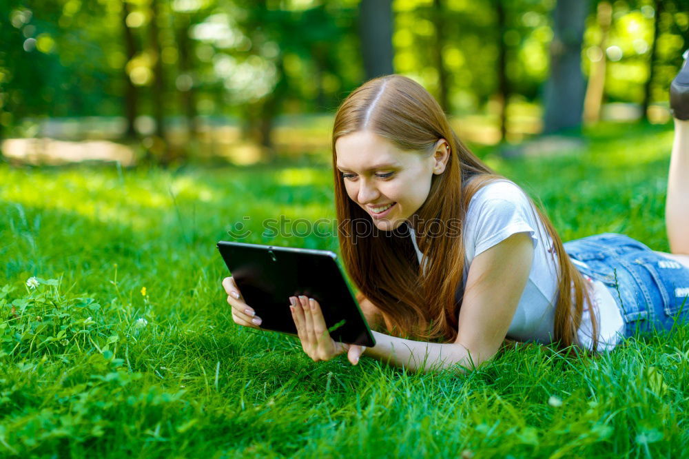 Similar – Image, Stock Photo Woman skateboarder listening music from smart phone in a park