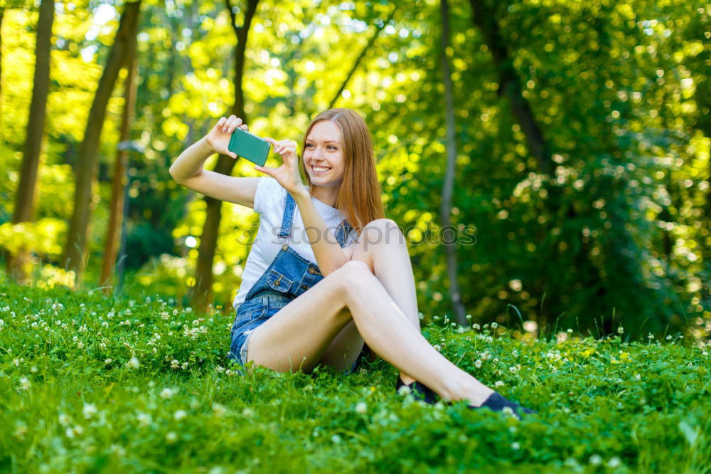 Similar – Happy little girl is smiling and  swinging  in the garden in a sunny summer day.