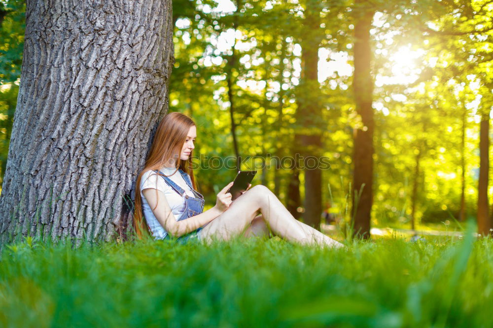 Similar – Woman reading a book outdoors