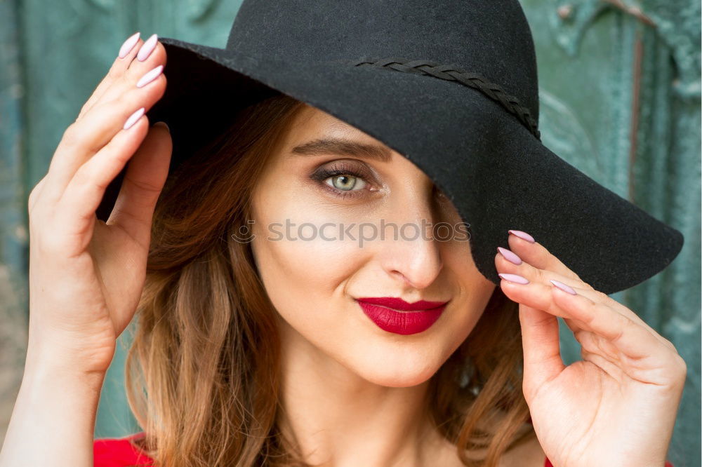 Similar – Young woman with black dress and red bow in her hair. Fashion photography. Autumn / winter fashion. Hair accessory.