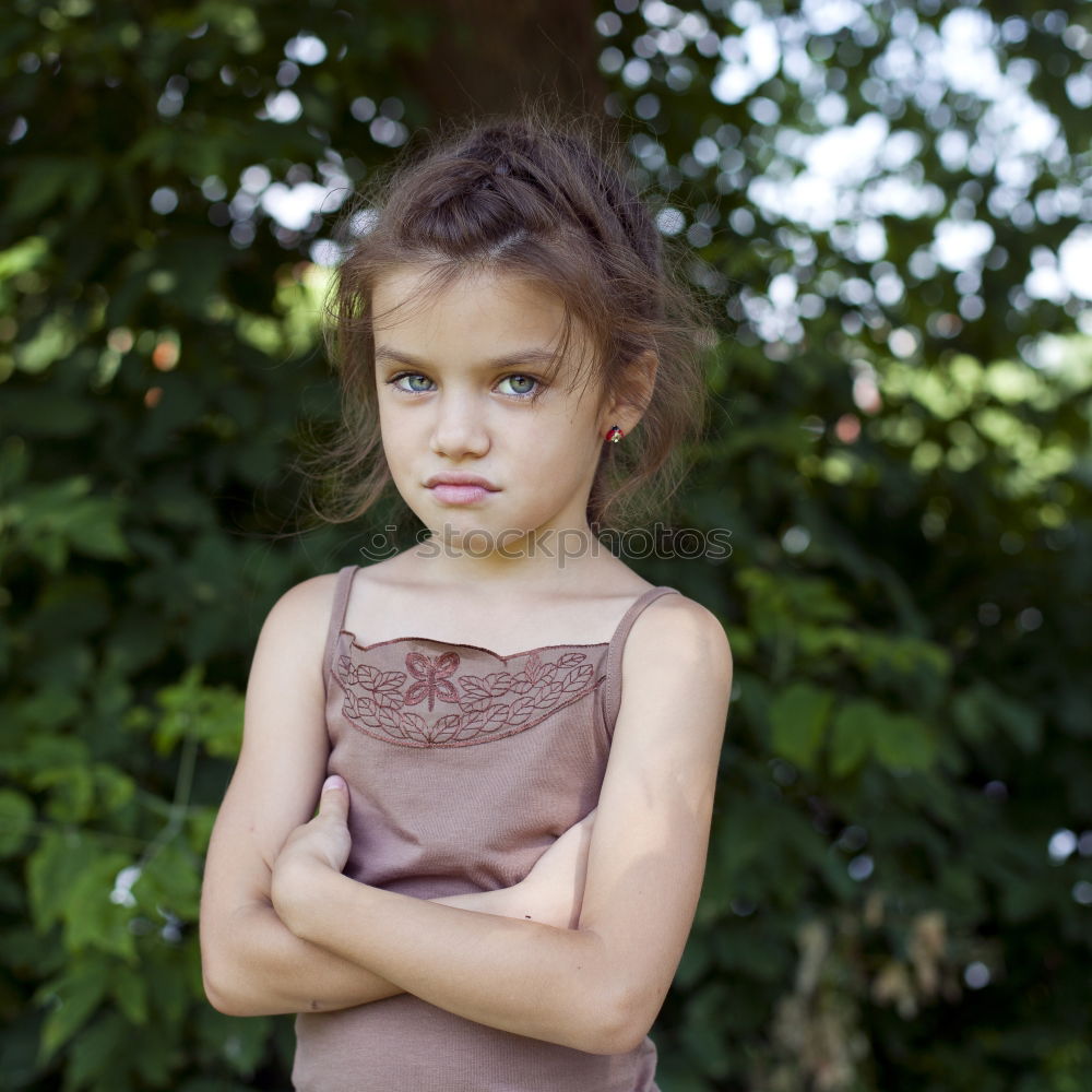 sad little girl holding toy with her hands