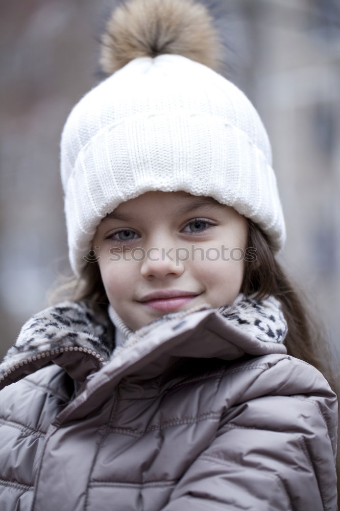 Portrait of young blonde woman in coat with fur