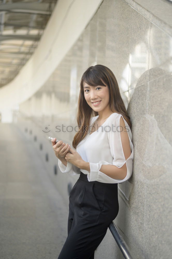 Similar – Woman standing on the street