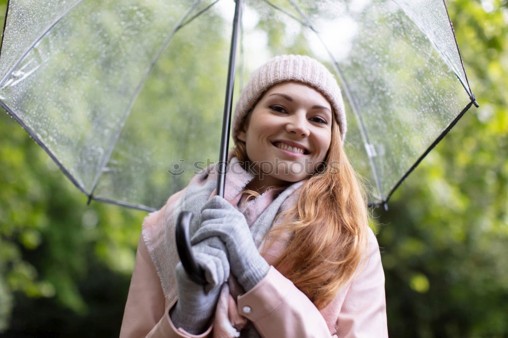 happy kid girl hiding under umbrella