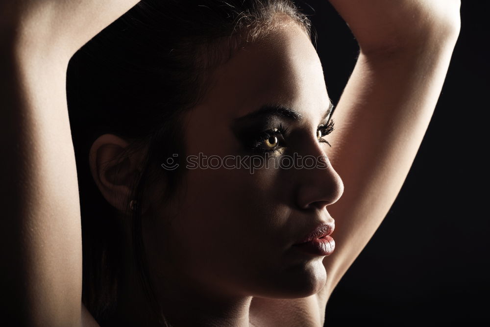 Similar – very close portrait of young beautiful dark skinned woman looking into camera from below