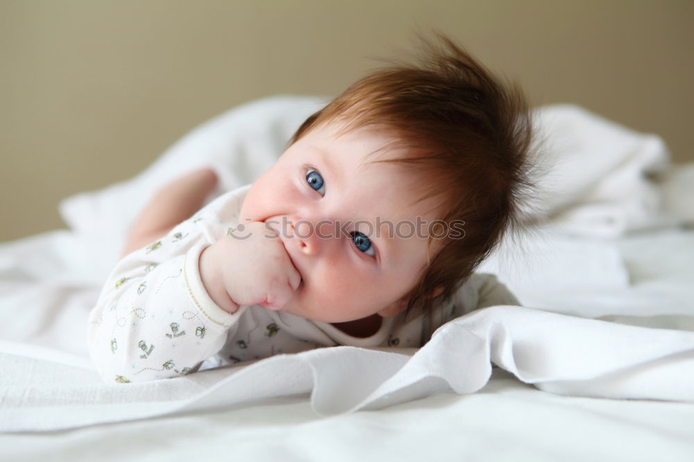 Image, Stock Photo Lovely newborn baby girl with a warm pajama at home