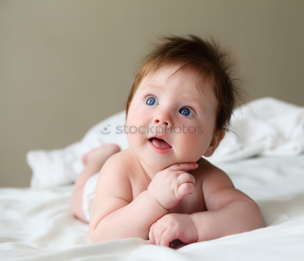 Similar – Baby with a colourful headscarf and blue eyes