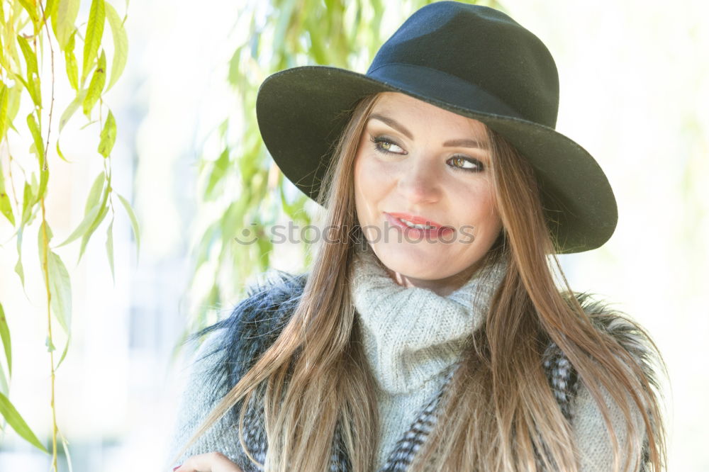 Similar – smiling young woman wearing winter coat with fake fur hood