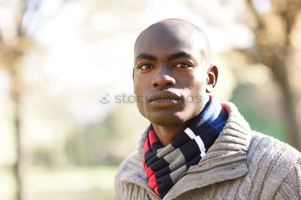 Similar – Black young man with arms crossed smiling in urban background