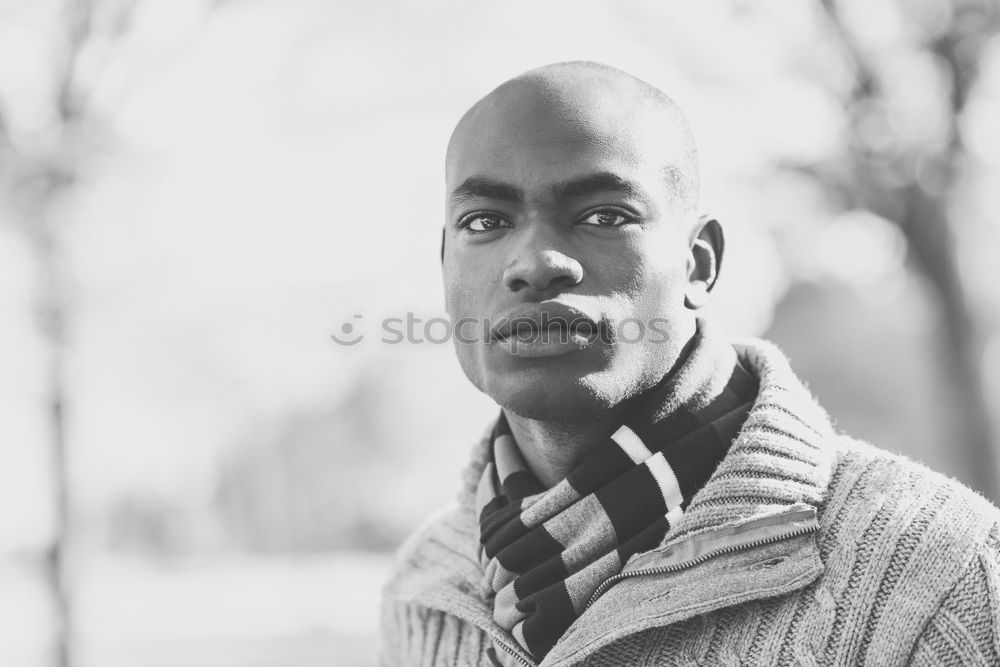 Similar – Black young man with arms crossed smiling in urban background