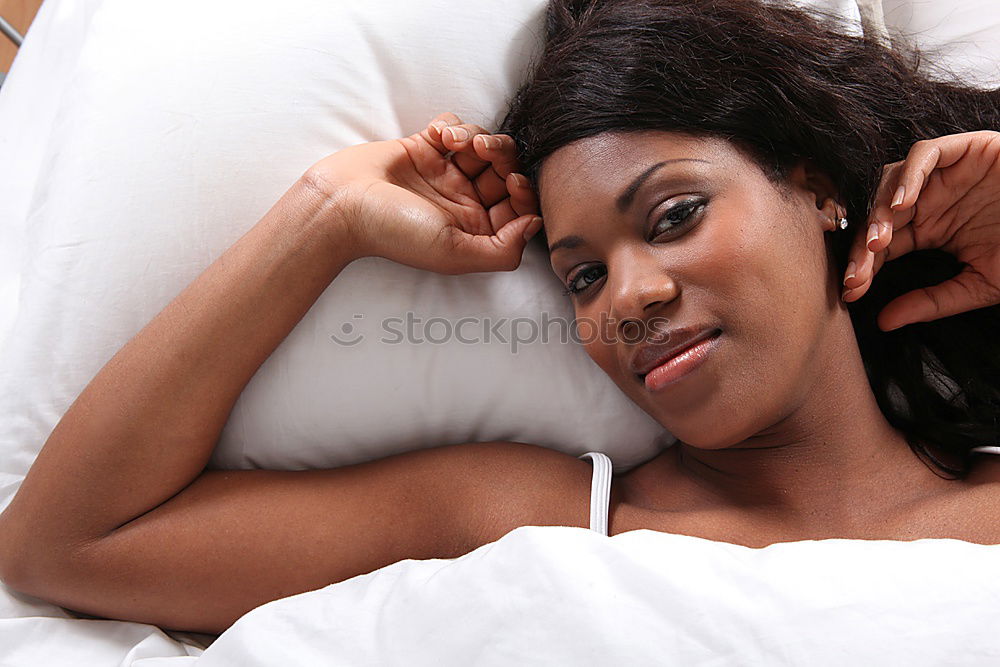 Similar – young dark skinned woman lies in lingerie on the bed and smiles into the camera