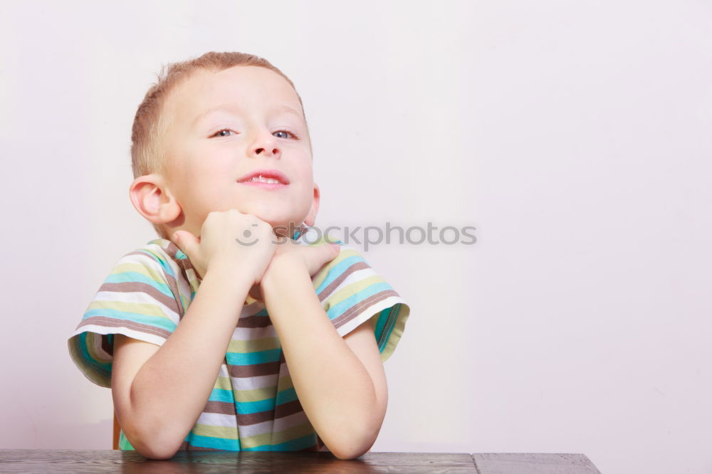 Similar – Happy boy sitting on the floor