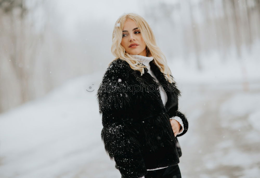 Similar – young woman 30 years in snow with red coat and leopard dress blond hair curly happy hopeful street