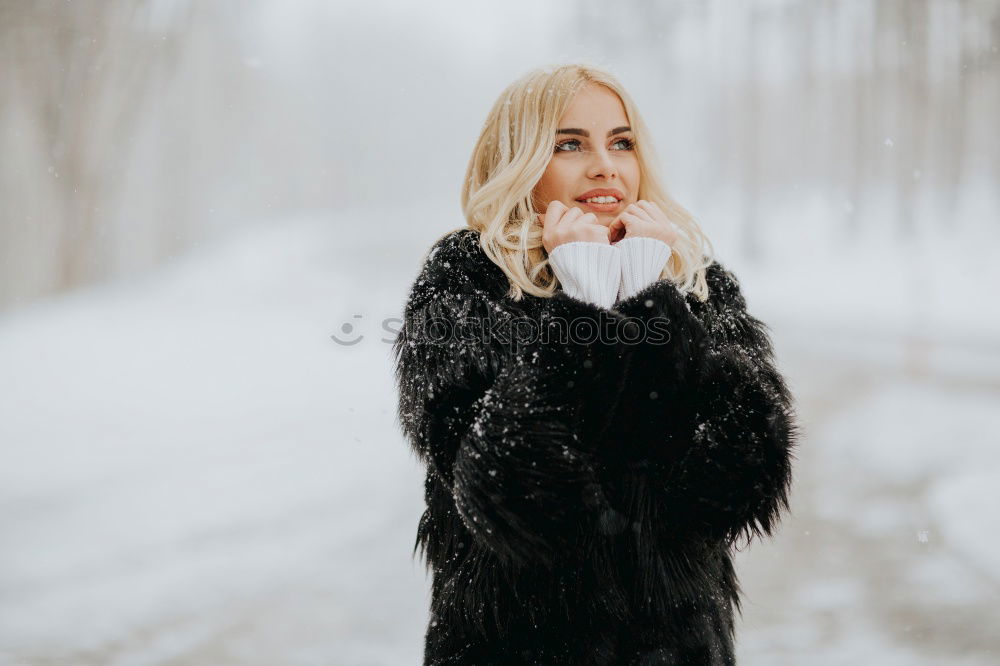 Similar – young woman 30 years in snow with red coat and leopard dress blond hair curly happy hopeful street