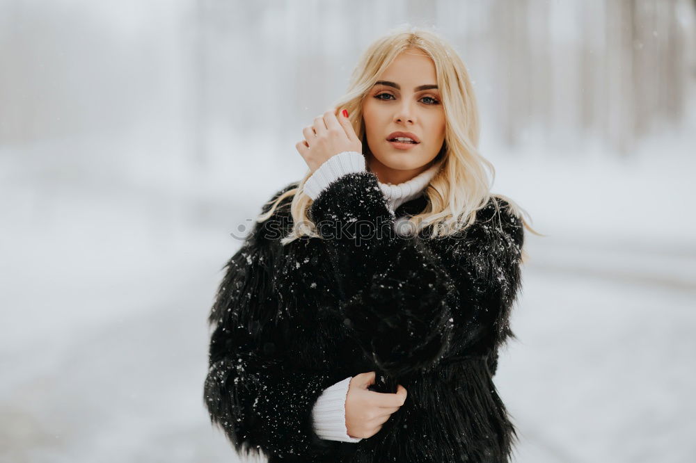 Similar – young woman 30 years in snow with red coat and leopard dress blond hair curly happy hopeful street