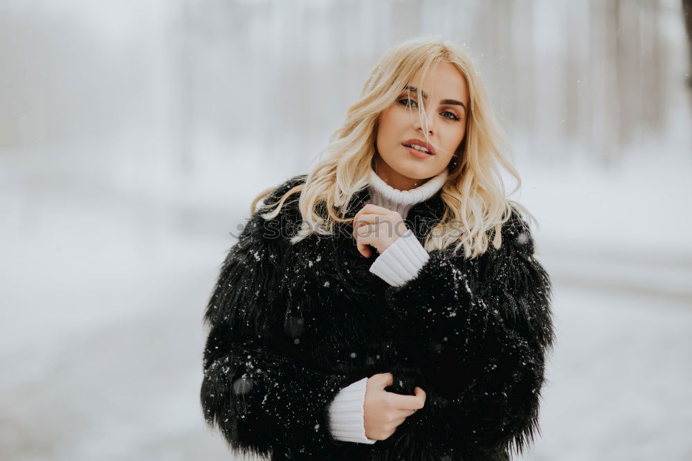 Similar – young woman 30 years in snow with red coat and leopard dress blond hair curly happy hopeful street