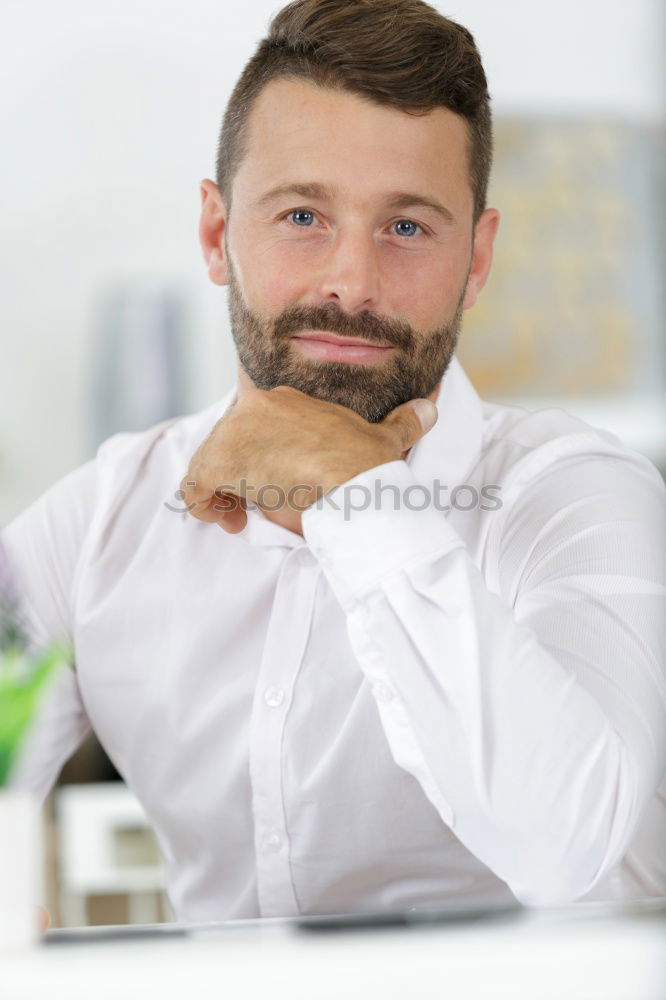 Bearded man in sunglasses looking at the window