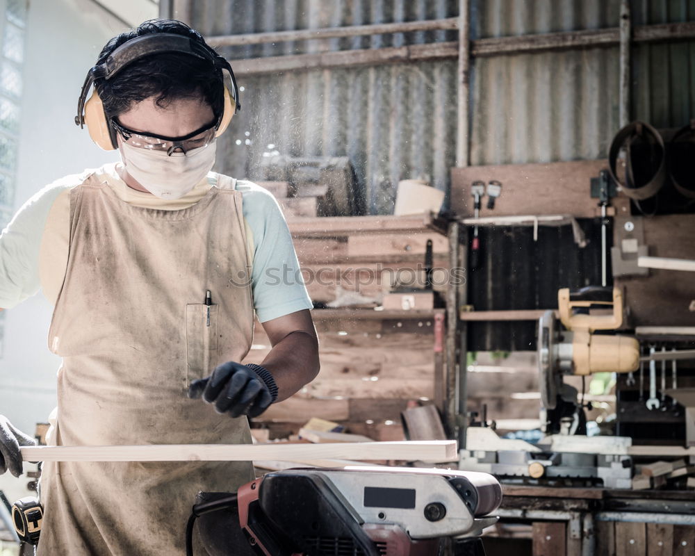 Similar – Carpenter cutting wooden board at his workshop