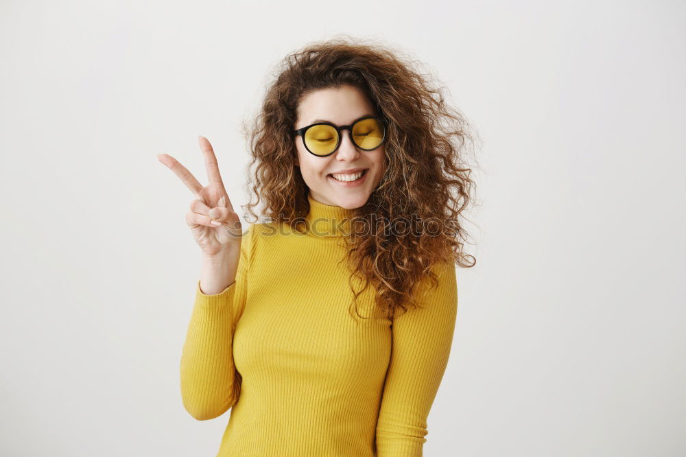 Similar – Image, Stock Photo Young redhead smiling woman in yellow hipster beanie cap pulls FFP2 mask away from face below