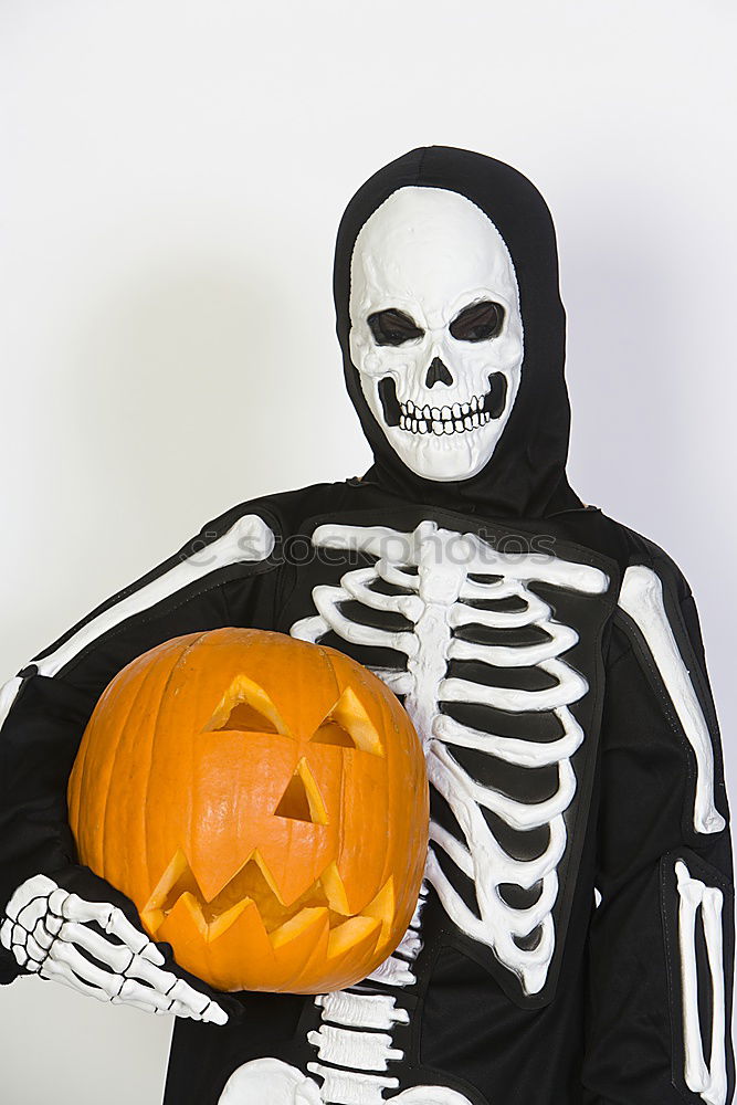 Similar – Image, Stock Photo Young boy in the Skeleton costume holding Halloween pumpkin