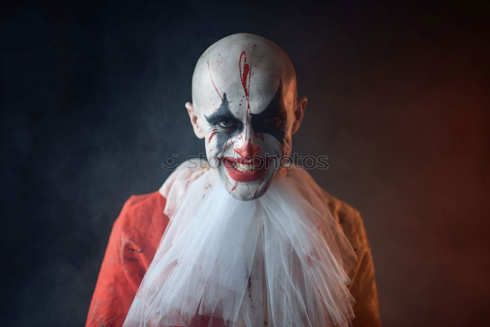 Similar – boy dressed as a clown on black background