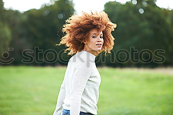 Similar – Young African American woman lying on grass