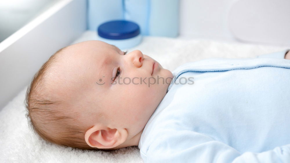 Similar – Baby toddler sits interested and curious in front of washing machine on the floor