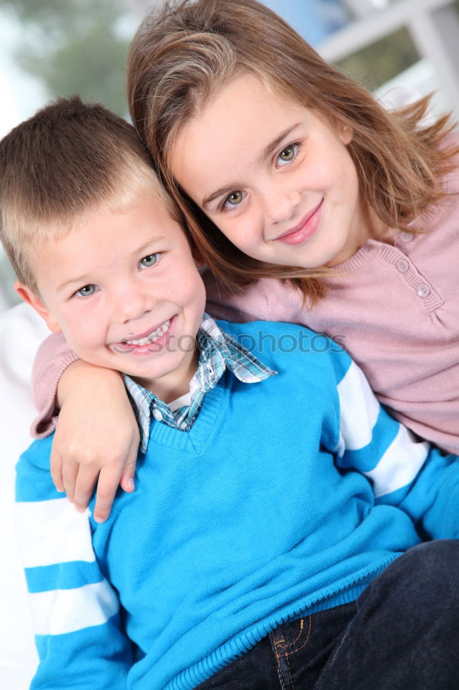 Similar – Two adorable young brothers outdoors in winter wrapped up warmly against the chill weather with the older boy cuddling his toddler sibling on his lap