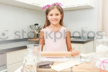 Similar – Image, Stock Photo Portrait of little girl preparing baking cookies.