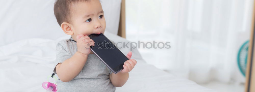 Similar – Baby in a bed in frame of heart shape. Out of focus baby