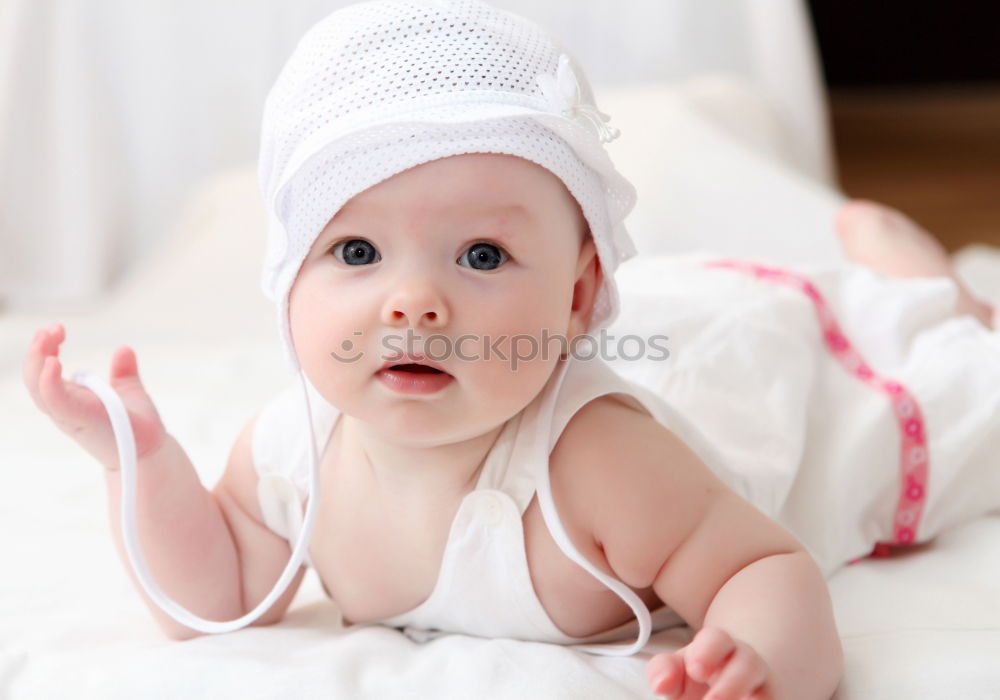 Similar – Baby with a colourful headscarf and blue eyes