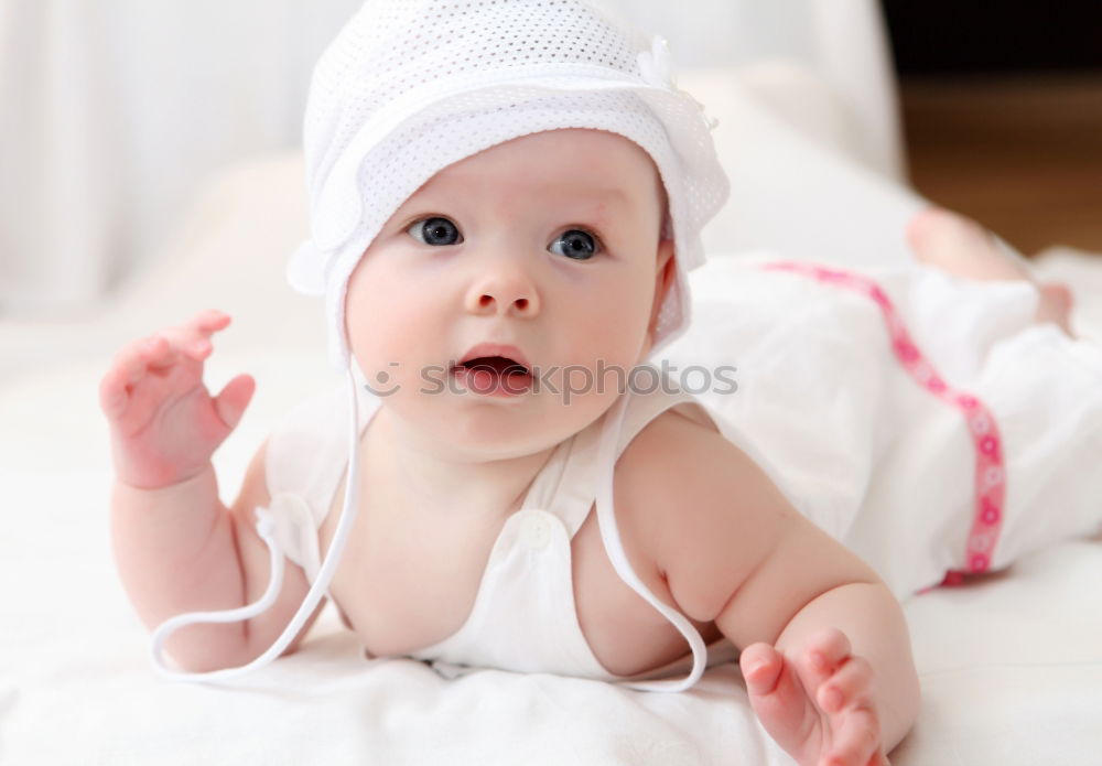 Similar – Baby with a colourful headscarf and blue eyes