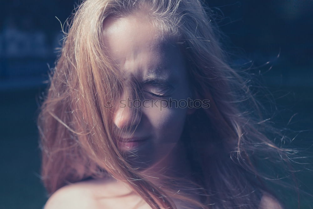 Portrait of a beautiful girl with big blue eyes looking at camera with surprised expression