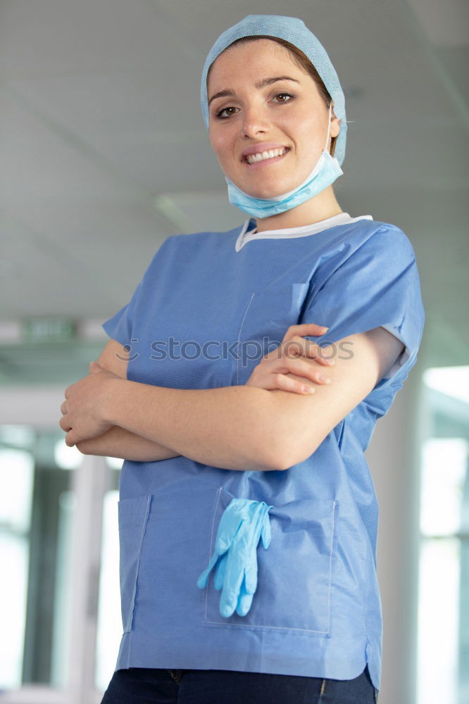 Similar – Smiling Female Doctor With Face Mask Wearing Scrubs In Busy Hospital During Health Pandemic