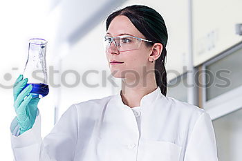 Similar – Image, Stock Photo Woman holding flask in lab