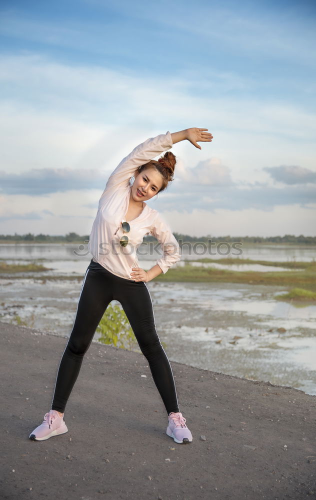 Similar – Woman stretching her body in front of ancient wall in park