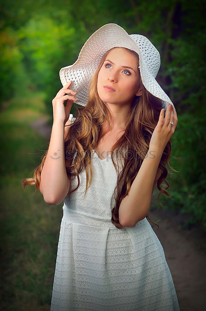 Similar – Pretty woman standing with white flowers